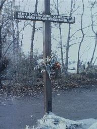 A cross in West Berlin marks site of last death at Wall, Spring '89