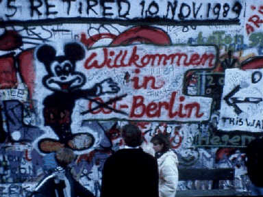 A Mickey Mouse cartoon on the Wall welcomes everyone to Berlin as a whole, with the word East, crossed out 