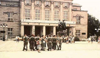 Weimar scene, a group of soldiers chatting, statues in background